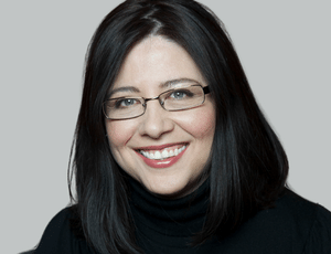 Employee headshot. Dr. Denise Milovan, PhD, MA, CPsych. Scientific Manager, Biostatistics, at Altasciences. Black hair, wearing glasses, smiling at camera in front of grey background.